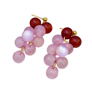 Detail shot of vintage grape cluster earrings with red and lilac translucent beads