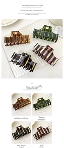 Macro detail of acrylic hair claw clips featuring striped patterns and heart cutouts