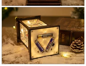 Close-up of vintage Christmas lantern showing LED lights and bottom battery compartment