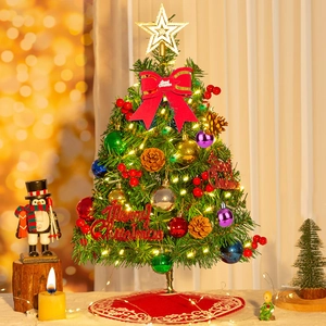 Mini tabletop Christmas tree with warm LED lights, colorful ornaments and red star topper