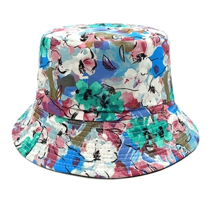 Detailed close-up of a double-sided bucket hat with colorful floral patterns and canvas fabric