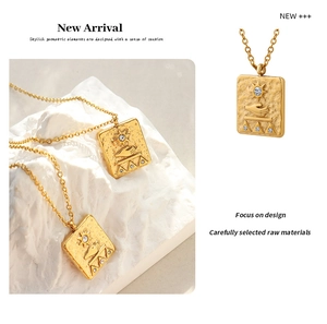 Detailed relief of sun and hand pattern on gold square pendant necklace with zircons