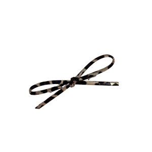 Bow hair clip with black and grey leopard pattern on a white background