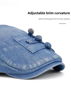 Detailed side view of washed denim beret featuring traditional knots and flexible brim