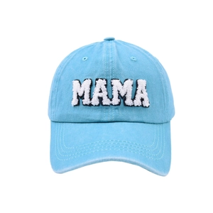 Close-up of sky blue washed cotton baseball cap featuring white MAMA towel embroidery