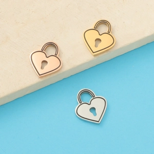 Macro detail of heart-shaped locker pendants in gold, silver, and rose gold finishes