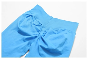 Detail of high-waist seamless yoga pants in bright blue with scrunch butt lifting design