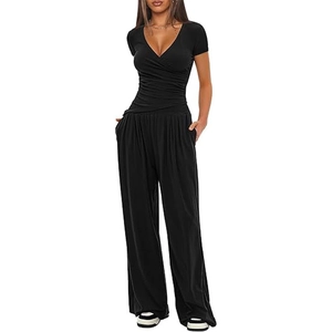 Detail view of black two-piece set featuring V-neck pleated waist top and wide-leg trousers
