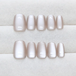 Short square nude pink cat eye press-on nails set with shimmer finish on white display