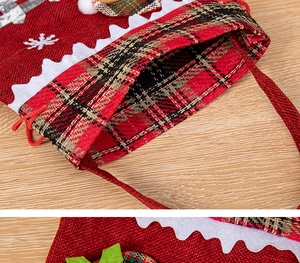 Detailed close-up of Christmas gift bag featuring red buffalo plaid and linen textures