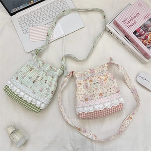 Detailed flat lay of quilted cotton crossbody bags with floral patterns and lace hearts