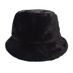 Close-up of fuzzy black faux fur bucket hat showcasing thick plush texture and winter warmth