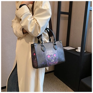 Detail of gothic skull print tote bag with purple glow and adjustable shoulder strap