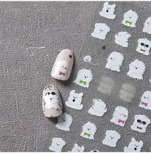 Detail of 5D cute white dog nail stickers applied on light pink nails with macro focus