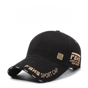 Detailed embroidery of gold letters and vintage metal badge on a black cotton baseball cap