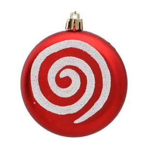 Detail of red matte Christmas ornament ball with white glitter spiral patterns and gold cap
