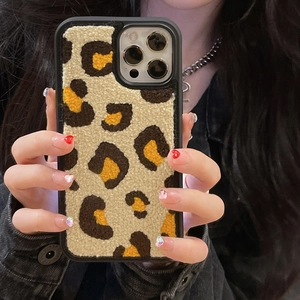 Detailed view of plush leopard print phone case texture for iPhone Pro models