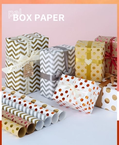 Detail of luxury gift wrap set with metallic gold patterns and Love Is Eternal ribbons
