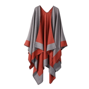 Detail of grey and orange double-sided reversible poncho wrap with striped trim