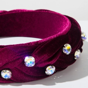 Close-up of velvet braided headband with sparkling rhinestones and colorful crystals