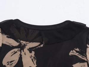 Detailed close-up of the round neckline with mesh insert and floral print pattern
