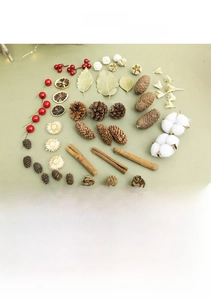 Flat lay of natural pine cones, cotton, cinnamon sticks and dried fruits for Christmas DIY