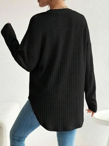 Back view of black long sleeve maternity top with ribbed knit texture and stylish fit