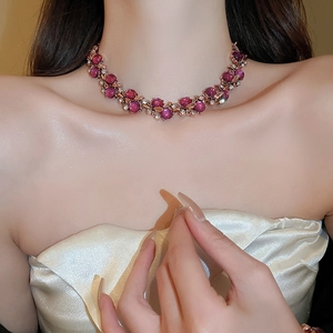 Close-up of vintage flower necklace with purple gemstones and diamonds worn by a model