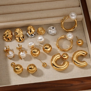 Elegant gold plated stainless steel pearl earring collection displayed in a wooden jewelry box