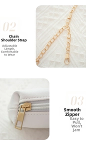 Detail of adjustable gold chain strap and smooth zipper on white embroidered crossbody bag