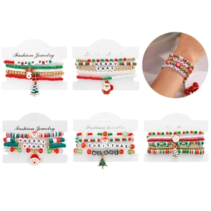 Close-up of Christmas beaded bracelets set with Santa, elk, and tree pendants