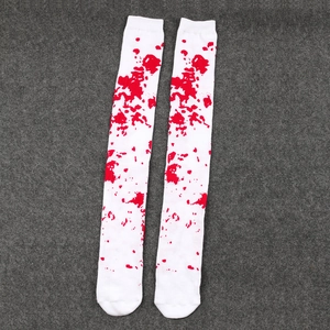 Close-up view of white over-the-knee socks with realistic red blood splatter print