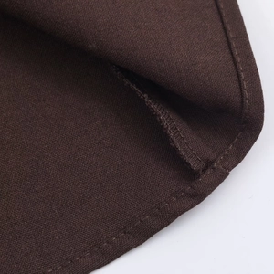 Detailed close-up of dark brown twill fabric texture and stitching on shirt dress