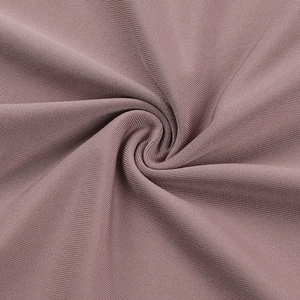 Macro shot of rose pink elastic knitted fabric with fine pleated texture and soft drape