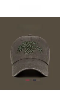 Close-up of vintage washed baseball cap with Boston Landscaping Co. 3D embroidery detail