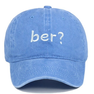 Detail shot of the white ber? embroidery on the blue washed vintage baseball cap