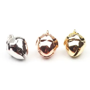 Bell charm set with micro-pave crystals in white, rose, and yellow gold finish