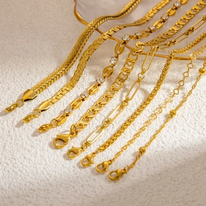 Detailed macro view of assorted 18k gold plated stainless steel Cuban and snake chains