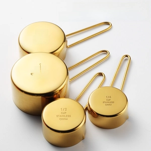 Set of 4 rose gold stainless steel measuring cups with wire handles for baking