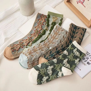 Detail of four pairs of vintage floral knit socks with cute rabbit patterns and textures