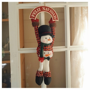 Christmas snowman hanger with red black plaid pattern and Feliz Navidad sign on window