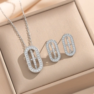 Silver oval rhinestone necklace and earrings set with arrow design in a jewelry box