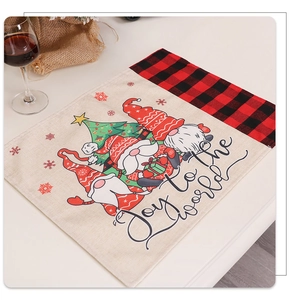 Christmas burlap placemat with gnome patterns and Joy to the World text on table