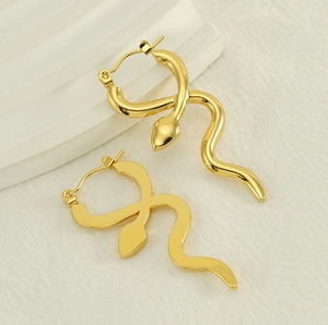 Detail of 18k gold plated snake hoop earrings with polished finish on white props