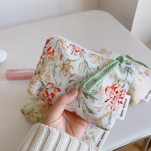 Detailed macro view of the small floral cotton pouch with metal zipper and pull rope