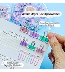 Hand holding macaron colored binder clips and paperclips in a clear organizer box