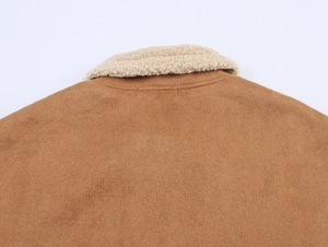 Detailed view of brown faux suede bomber jacket with white faux shearling collar trim