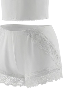 Detail showing the white lace edges and smooth fabric of the two-piece lingerie set
