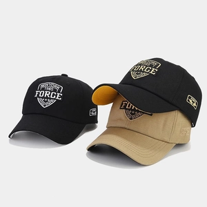 Detail of vintage high-top baseball caps with 1985 Force shield embroidery in black and khaki