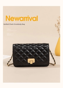 Close-up of black quilted shoulder bag featuring gold metal clasp and chain strap detail